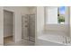 Bathroom with soaking tub, walk-in shower, and marble tile at 268 Umstead St, Sanford, NC 27330