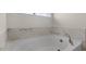 Relaxing bathroom with a soaking tub and marble tile at 268 Umstead St, Sanford, NC 27330