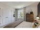 Bright bedroom with a double door closet and a large window at 732 Apple Churn Dr, Fuquay Varina, NC 27526