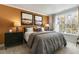 Bright bedroom with a king-size bed, large window, and an accent wall at 732 Apple Churn Dr, Fuquay Varina, NC 27526