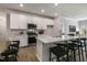 Modern kitchen with white cabinets, large island, and stainless steel appliances at 732 Apple Churn Dr, Fuquay Varina, NC 27526