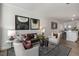 Spacious living room with a leather sofa, two armchairs, and a glass coffee table at 732 Apple Churn Dr, Fuquay Varina, NC 27526