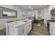 Modern kitchen with a large island, white cabinets, and quartz countertops at 732 Apple Churn Dr, Fuquay Varina, NC 27526