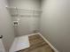 Convenient laundry room with shelving and vinyl flooring at 726 Sherrill Farm Dr, Benson, NC 27504