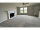 Spacious living room featuring a fireplace and large windows at 726 Sherrill Farm Dr, Benson, NC 27504