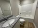 Bathroom with granite countertop, tub and flooring at 726 Sherrill Farm Dr, Benson, NC 27504