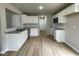 Modern kitchen with white cabinets, granite countertops, and LVP flooring at 726 Sherrill Farm Dr, Benson, NC 27504