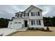 Two-story home with a two-car garage and landscaping at 726 Sherrill Farm Dr, Benson, NC 27504