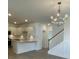 Modern kitchen with white cabinets, quartz countertops, and stainless steel appliances at 137 Swain St, Clayton, NC 27527