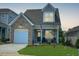 Two-story house with brick and gray siding, and two-car garage at 137 Swain St, Clayton, NC 27527