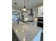 Modern kitchen with white cabinets, quartz countertops, and stainless steel appliances at 124 Swain St, Clayton, NC 27527