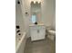 Small bathroom with a toilet, vanity, and a bathtub at 124 Swain St, Clayton, NC 27527