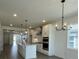 Island kitchen with white cabinets, quartz countertops, and stainless steel appliances at 124 Swain St, Clayton, NC 27527