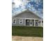 Covered patio with ceiling fan, access from the house and a grassy backyard at 124 Swain St, Clayton, NC 27527