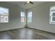 Bright bedroom with wood-look flooring and multiple windows at 124 Swain St, Clayton, NC 27527