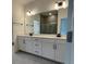 Elegant bathroom with double vanity, large mirror, and a walk-in shower at 124 Swain St, Clayton, NC 27527