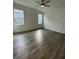 Well-lit bedroom featuring wood-look floors and two windows at 124 Swain St, Clayton, NC 27527