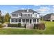 Two-story home with white siding, gray roof, and a brick walkway at 160 Lochmaddy Dr, Burlington, NC 27215