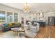 Open living room features a stylish sofa, armchairs, and a mid-century modern coffee table at 465 Douglas Falls Dr, Wendell, NC 27591
