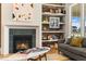 Modern gas fireplace with green tile surround and built-in shelving at 465 Douglas Falls Dr, Wendell, NC 27591