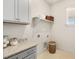 Well-equipped laundry room with granite countertop and cabinets at 465 Douglas Falls Dr, Wendell, NC 27591