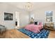 Spacious bedroom with pink bedding, blue rug, and en-suite bathroom access at 465 Douglas Falls Dr, Wendell, NC 27591