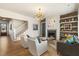 Open living room with hardwood floors, fireplace and stylish mid-century modern furniture at 465 Douglas Falls Dr, Wendell, NC 27591
