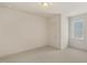 Bright bedroom with neutral walls and carpet, featuring a window and closet at 465 Douglas Falls Dr, Wendell, NC 27591