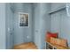 Bright hallway with blue walls, wooden floors, and built-in storage at 465 Douglas Falls Dr, Wendell, NC 27591