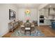 Elegant dining room with a wood table, statement chandelier, and patterned rug at 465 Douglas Falls Dr, Wendell, NC 27591