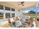 Relaxing back porch with wooden furniture and ceiling fan at 465 Douglas Falls Dr, Wendell, NC 27591