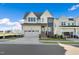 Two-story modern farmhouse with gray and white exterior, two car garage at 465 Douglas Falls Dr, Wendell, NC 27591