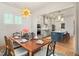 Bright dining room features a live edge table and stylish chandelier at 465 Douglas Falls Dr, Wendell, NC 27591