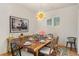 Elegant dining room features a wood table, chandelier, and statement art at 465 Douglas Falls Dr, Wendell, NC 27591