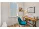Bright home office with wood desk, teal chair, and inspiring wall art at 465 Douglas Falls Dr, Wendell, NC 27591