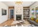 Spacious living area with hardwood floors, fireplace and built in shelving at 465 Douglas Falls Dr, Wendell, NC 27591