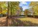 Large backyard with a two-story home and wooden deck at 1608 Irving Place, Creedmoor, NC 27522