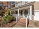 Front porch with brick steps and white railings at 1608 Irving Place, Creedmoor, NC 27522