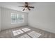 Well-lit bedroom with neutral carpet and window at 1608 Irving Place, Creedmoor, NC 27522