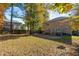 Large backyard with mature trees and wooden deck at 1608 Irving Place, Creedmoor, NC 27522