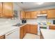 Bright kitchen featuring wood cabinets and stainless steel appliances at 1412 Hanford Hills Rd, Graham, NC 27253