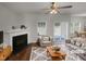 Virtually staged living room with fireplace, hardwood floors and sliding glass doors at 3122 Genlee Dr, Durham, NC 27704
