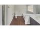 Main bathroom with a bathtub, double vanity, and dark brown cabinets at 3181 Hardie St, Creedmoor, NC 27522