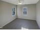 Bright bedroom with neutral walls, carpet flooring, and two large windows at 3181 Hardie St, Creedmoor, NC 27522