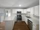 Modern kitchen with white cabinets, stainless steel appliances, and a large island at 3181 Hardie St, Creedmoor, NC 27522