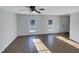 Living room with hardwood floors and large windows offering abundant natural light at 3181 Hardie St, Creedmoor, NC 27522