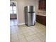 Kitchen features stainless steel refrigerator and tile flooring at 327 Ranch Farm Rd, Raleigh, NC 27603