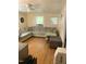 Living room features hardwood floors, a sectional sofa and ceiling fan at 327 Ranch Farm Rd, Raleigh, NC 27603