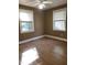 Spacious bedroom with wood-look flooring and two windows at 327 Ranch Farm Rd, Raleigh, NC 27603