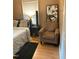 Bedroom with hardwood floors, a queen bed and comfortable armchair at 327 Ranch Farm Rd, Raleigh, NC 27603